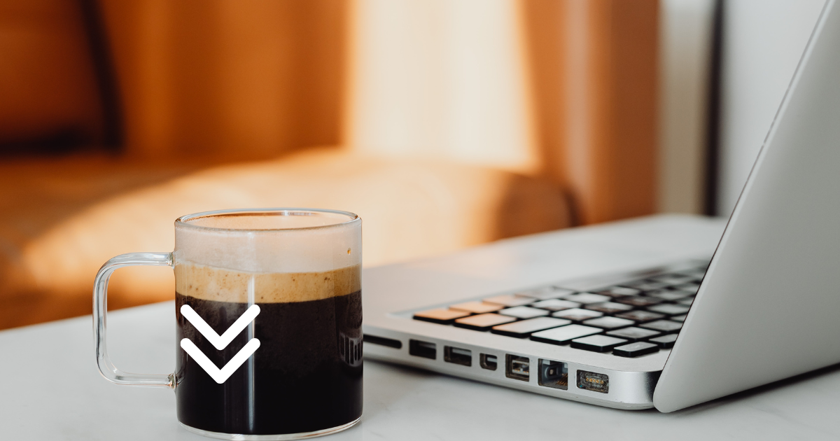 Closeup of desk with laptop and cup of coffee